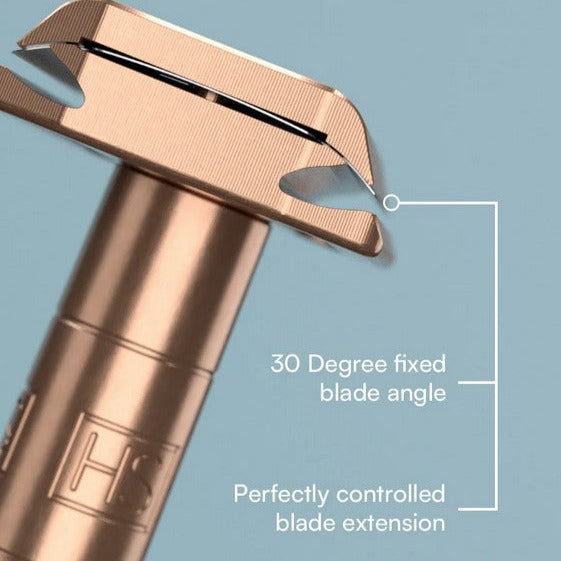 Close-up of the Henson AL13 Copper Razor head showing 30-degree fixed blade angle and perfectly controlled blade extension on a light blue background.