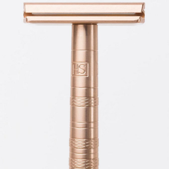 Close-up of Henson AL13 Copper Razor handle with textured grip and engraved logo