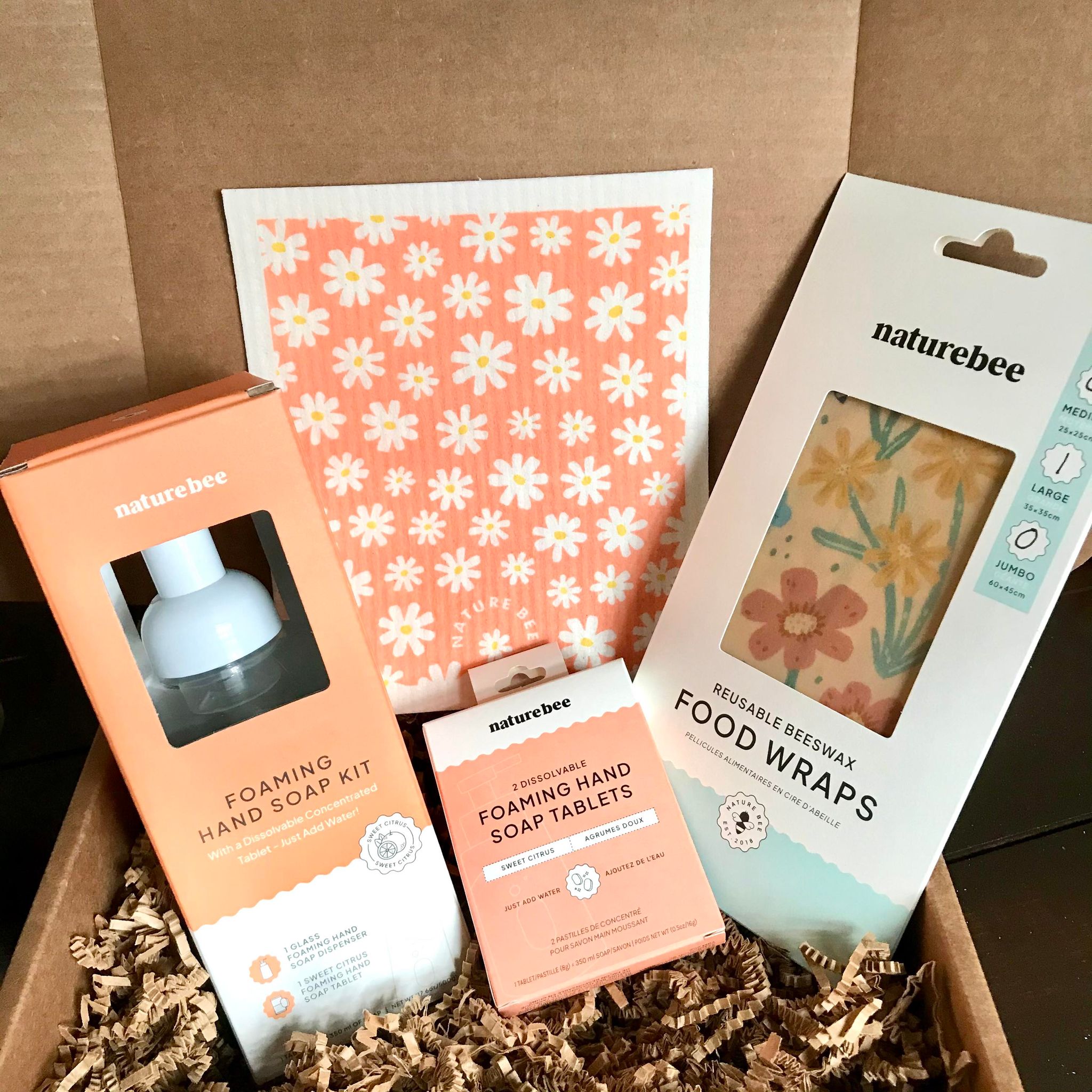 Included in this zero waste kitchen set is Swedish sponge cloth in a daisy pattern, a sweet citrus foaming hand soap kit, a set of two sweet citrus foaming hand soap tablets and a large green 'wildflower' beeswax wrap.