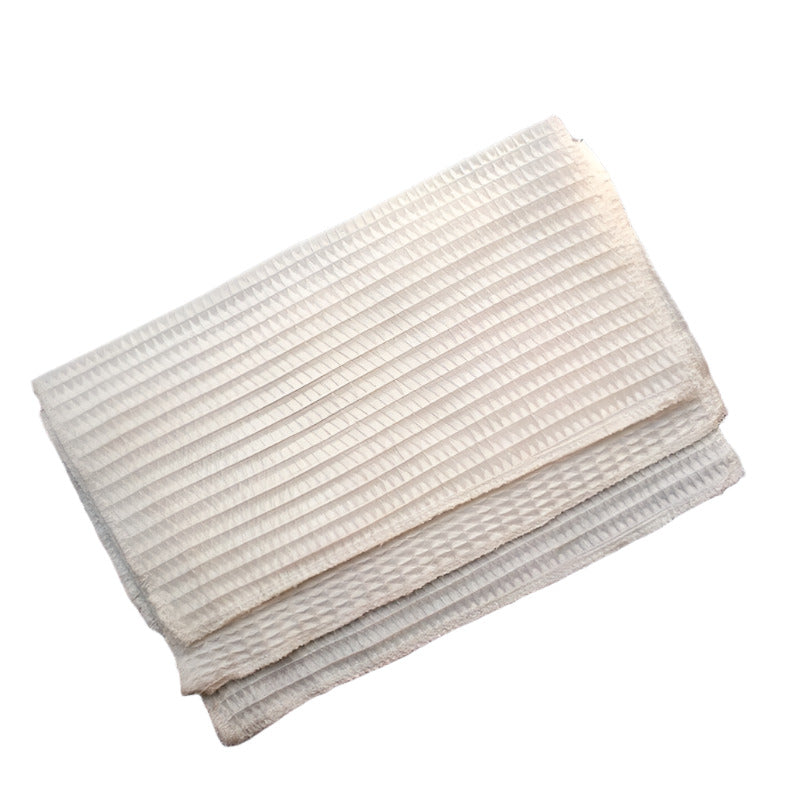 Three folded ivory bamboo cloth on a white surface