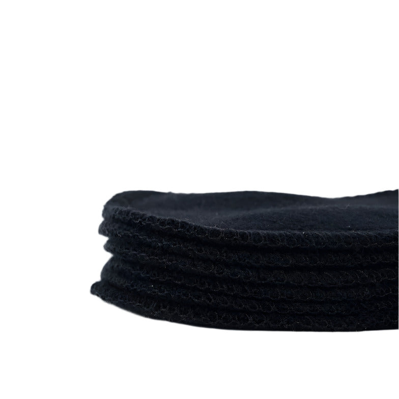 A stack of 6 black reusable hemp facial rounds by Cheeks Ahoy on a white background