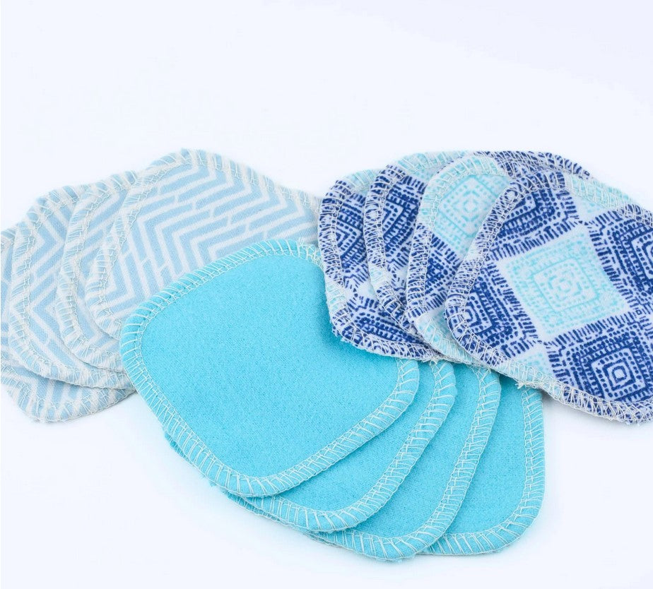 Set of blue and patterned cloth pads on a white background