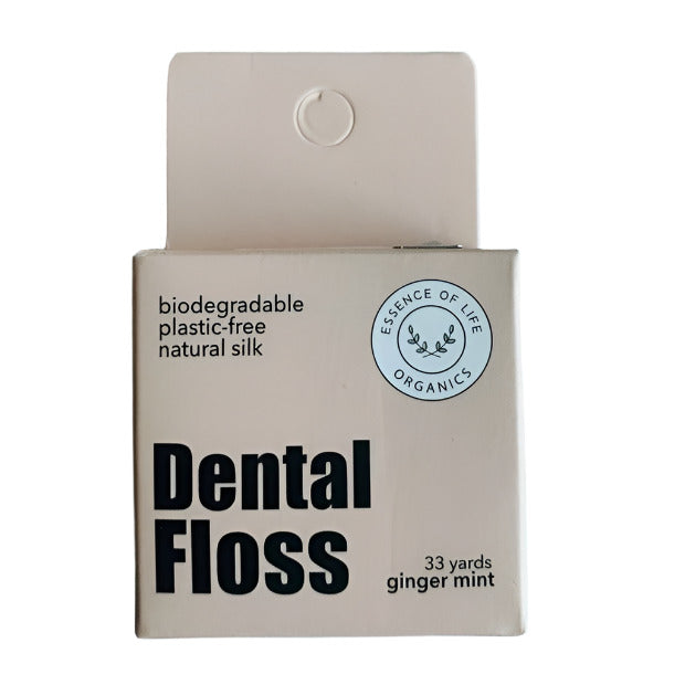 Essence of Life Organics biodegradable silk dental floss in ginger mint, 33 yards, in a beige cardboard box with cutter on top, made in Canada. Shown on a white background.