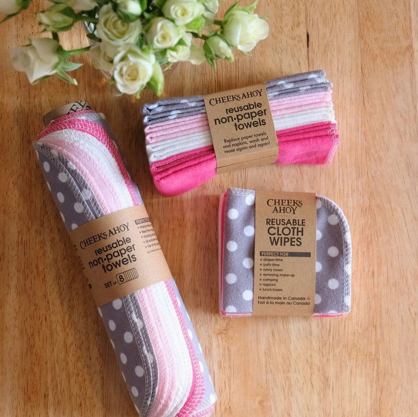 Flat lay of Peekaboo reusable non-paper towels and cloth wipes by Cheeks Ahoy with floral accent on wooden table