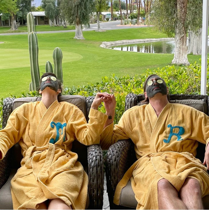 The bentonite clay in this Birch Babe face mask worn by a couple in robes helps remove toxins from  their skin while activated charcoal cleanses pores and soothes acne.