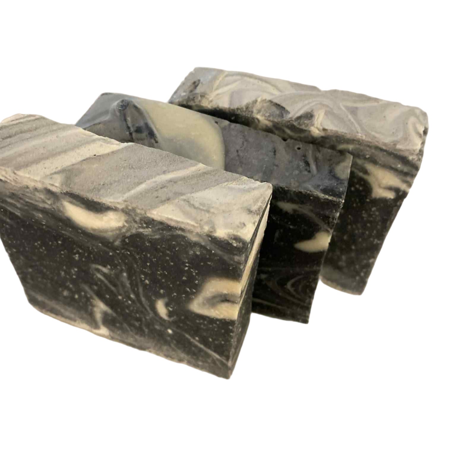 Three bars of black and white marbled Canadian made soap on a white background