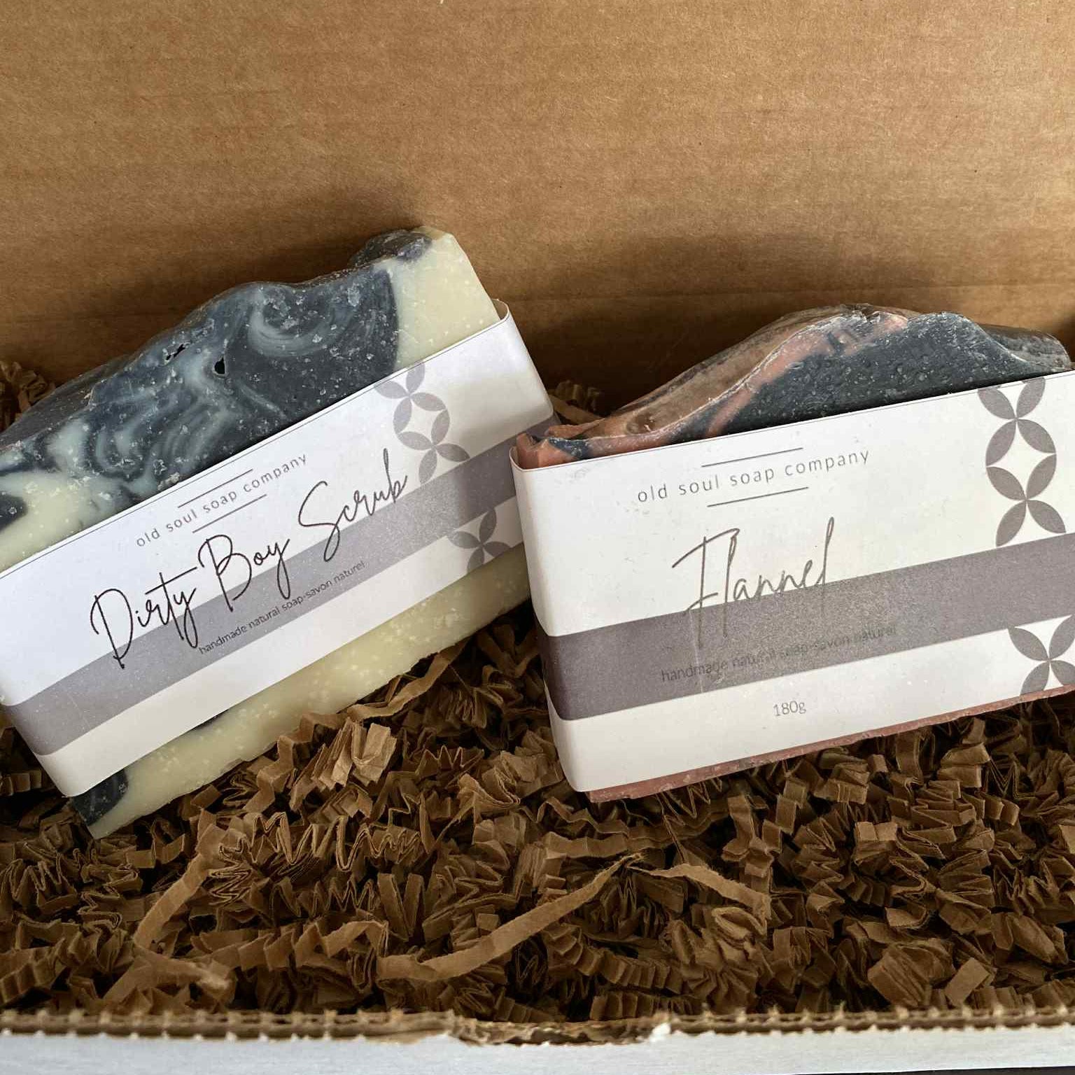 Eco-friendly Dirty Boy Flannel Soap Gift Box featuring two Canadian-made artisan soaps by the Old Soul Soap Company — Dirty Boy Scrub and Flannel — nestled in recyclable kraft packaging with paper filler, perfect for sustainable gifting.