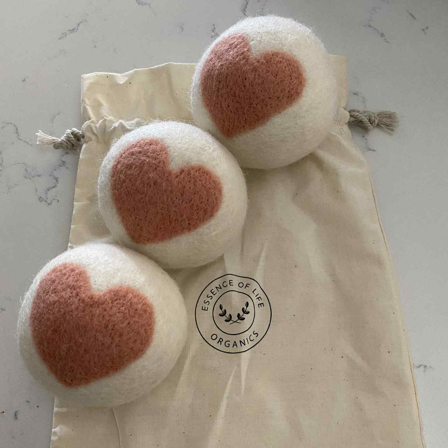 Essence of Life organic wool dryer balls with pink hearts | sustainable plastic-free laundry solution