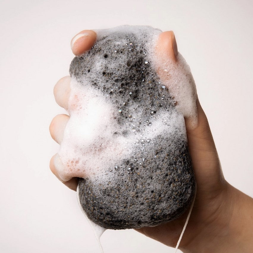 Everist Compostable Black Konjac Body Sponge creating foamy lather for gentle exfoliation