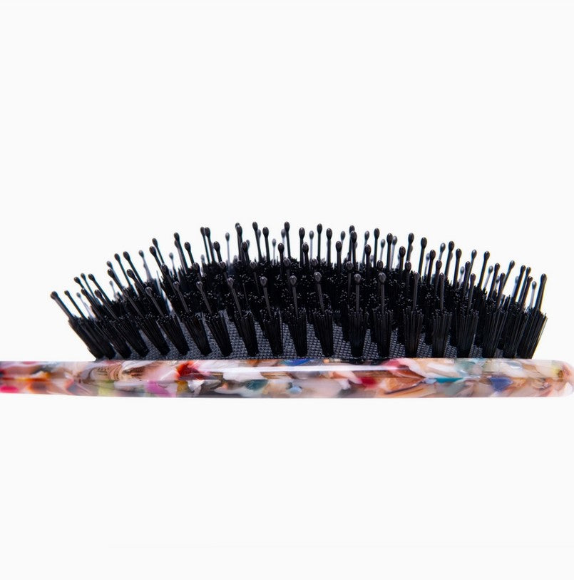 Close-up side view of Everist Smooth & Shine Hair Brush showing flexible ball-tipped bristles for gentle detangling and scalp massage.