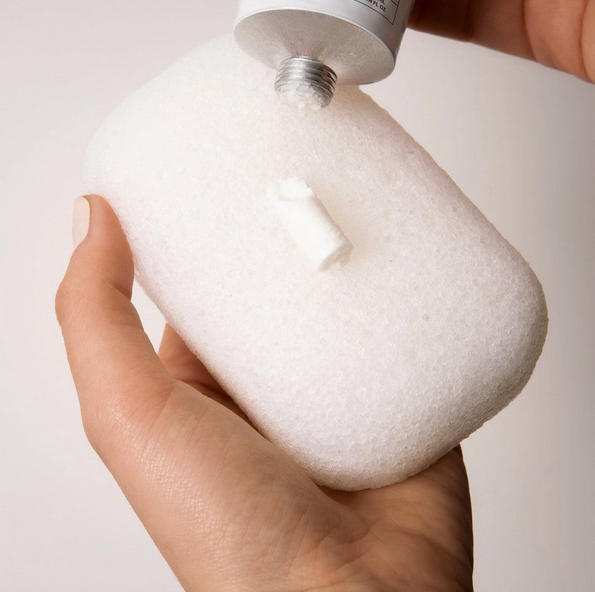 Everist Compostable Konjac Body Sponge being used with Everist Body Wash Concentrate, showing eco-friendly sustainable shower essentials.