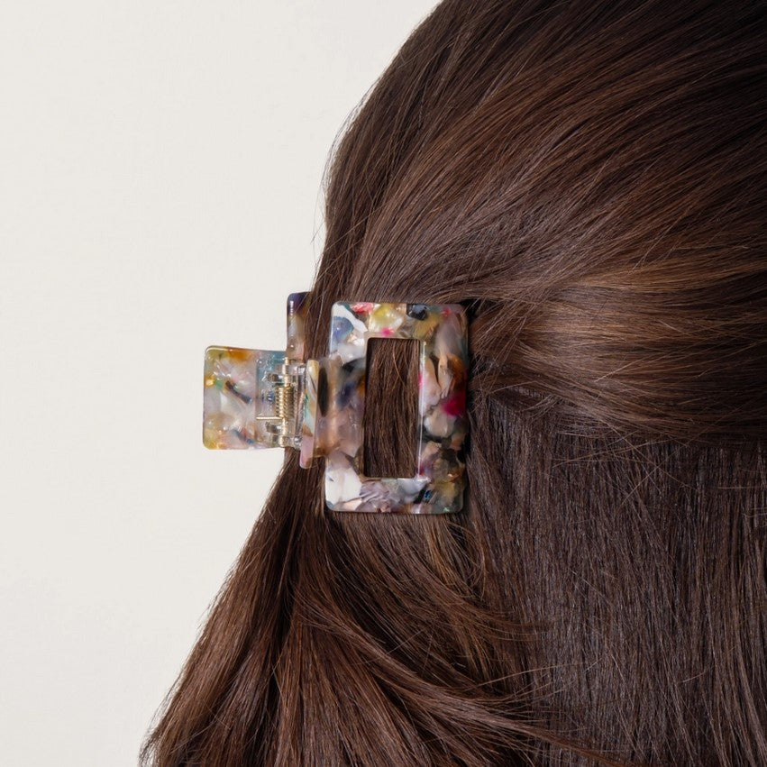 Everist Small Confetti Claw Clip holding brunette hair securely in place – sustainable recycled hair accessory with unique confetti pattern