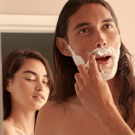 Man shaving with Henson AL13 safety razor while woman looks on