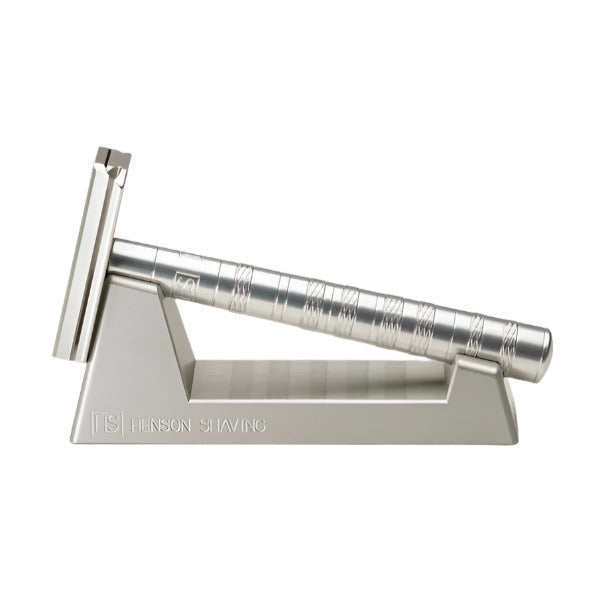 Silver Henson Razor resting in matching anodized aluminum razor stand