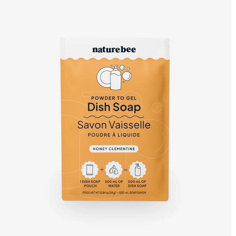 A packet of honey clementine nature bee powder to gel dish soap on a white background. This single dish soap pouch when added to 500 ml of water makes 500 m of dish soap.