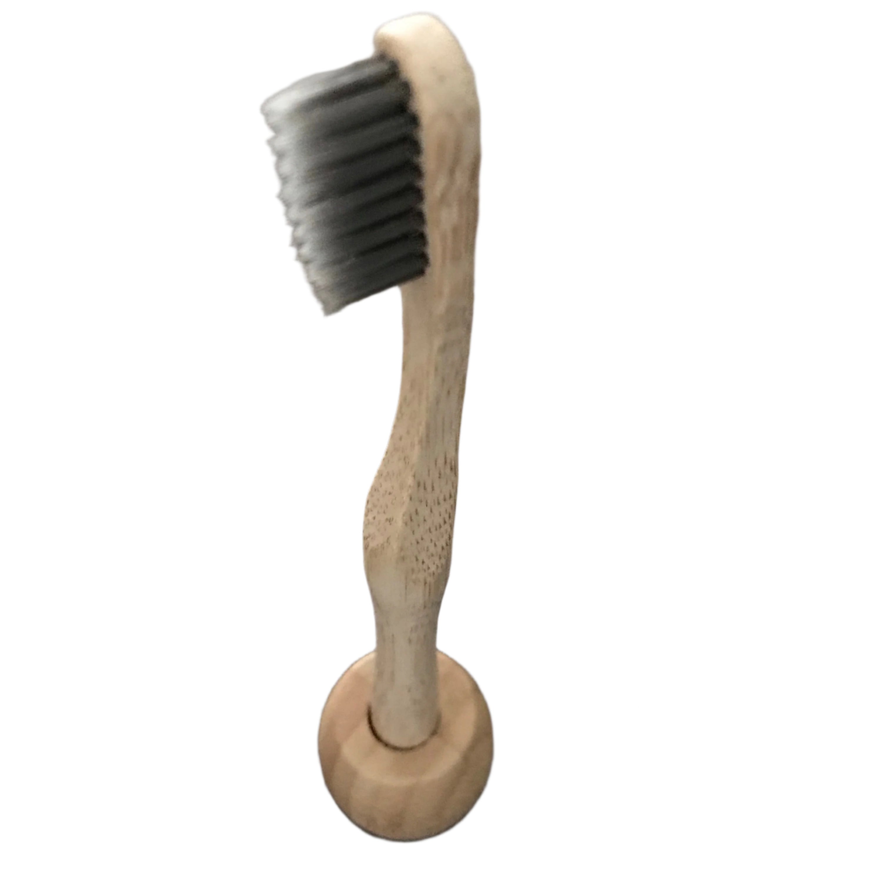 allBambu toothbrush with charcoal bristles in an individual bamboo toothbrush holder on a white background