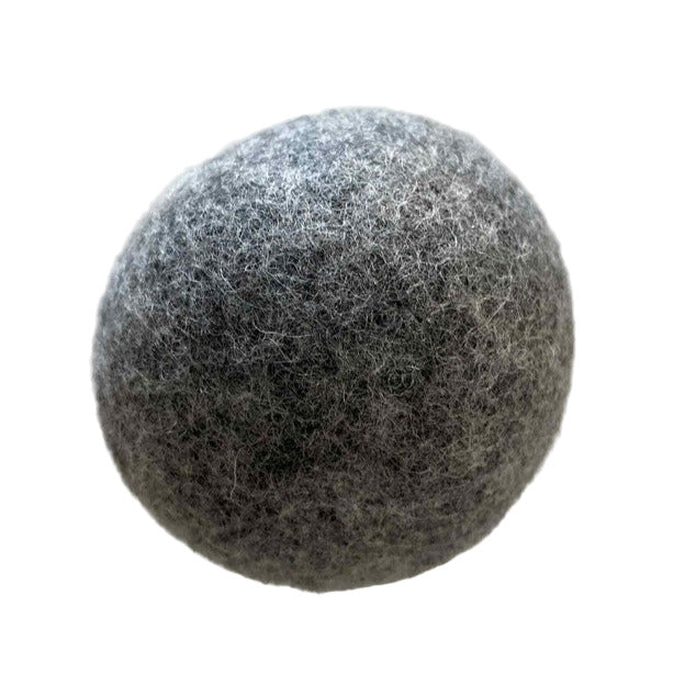 Close-up of single charcoal Earthly Change wool dryer ball – plastic-free, natural laundry solution