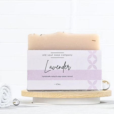 old soul soap company handcrafted natural vegan soap 180 g made in canada with a lavender label sitting on a wood tray