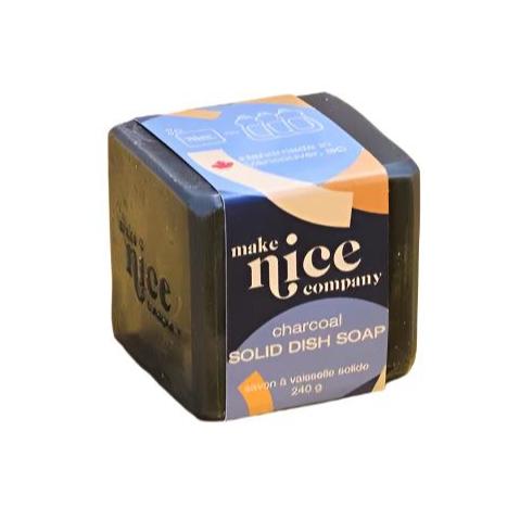 A labelled unscented activated charcoal solid dish soap cube 240 g made in Canada by the Make Nice Company on a white background