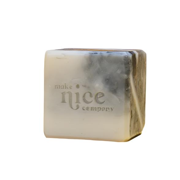 Unlabelled and scented solid dish soap cube 240 g on a white background made in Canada by the Make Nice Company with white and charcoal dish soap bar scraps