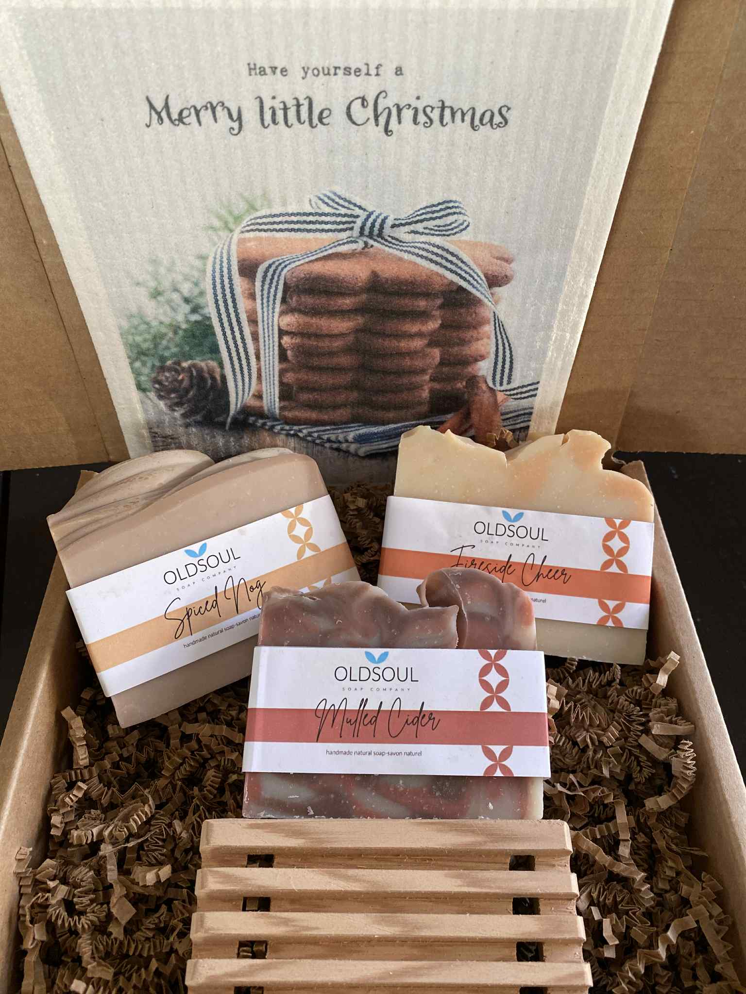 Merry Little Christmas Soap Gift Box featuring three Canadian-made Old Soul Soap Company bars—Spiced Nog, Fireside Cheer, and Mulled Cider—paired with a “Have Yourself a Merry Little Christmas” Swedish dishcloth by More Joy and a handcrafted reclaimed cedar soap dish in eco-friendly packaging.