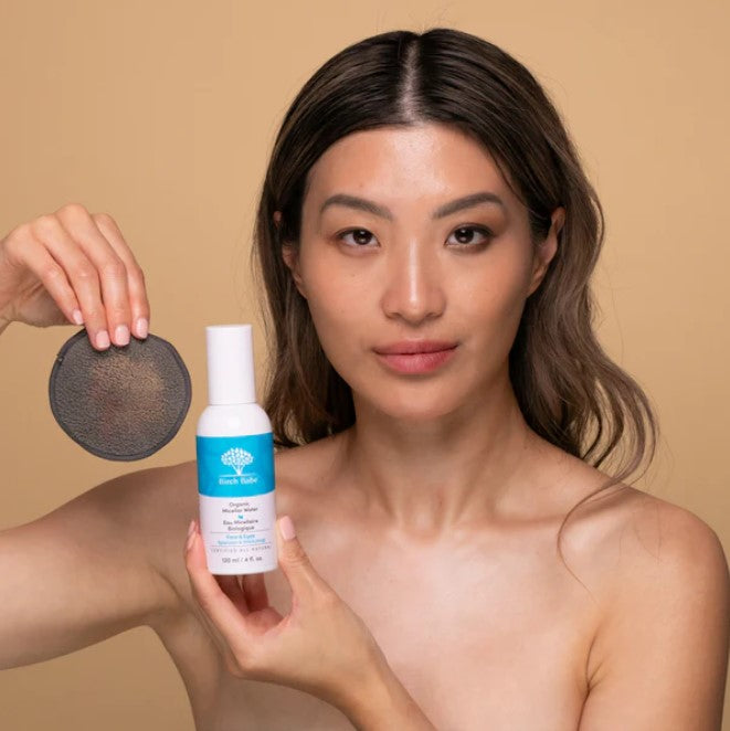 women after applying birch babe's 95% organic canadian made miscellar cleansing water with a bamboo charcoal reusable makeup remover pad