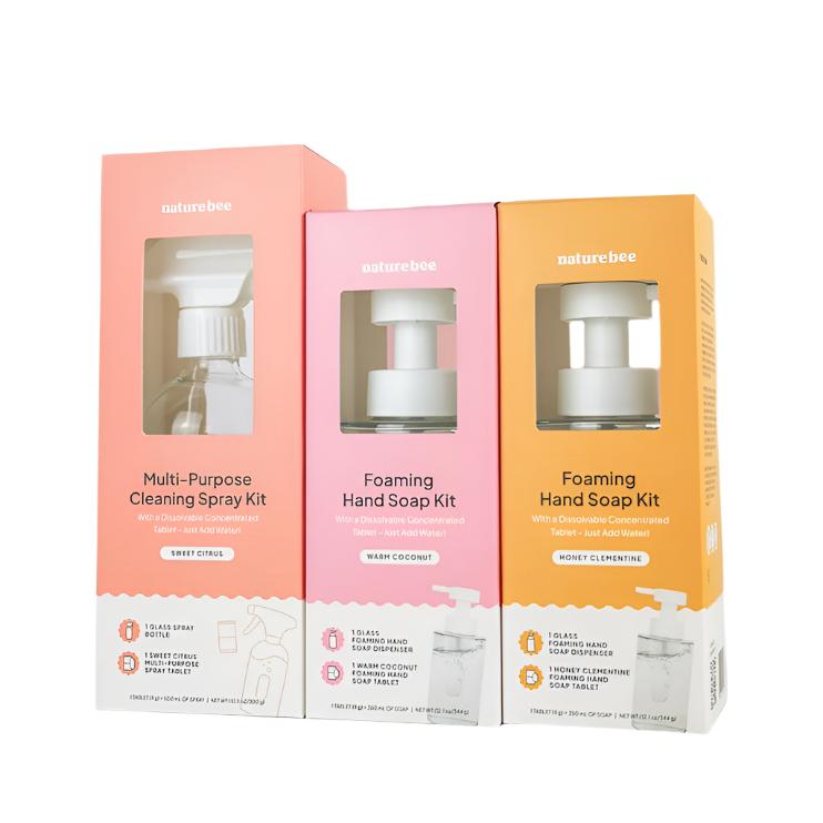 This Nature Bee Cleaning starter bundle includes a sweet citrus multi-purpose cleaning spray kit, a warm coconut foaming hand soap kit and a honey clementine foaming hand soap kit pictured in individual product boxes on a white background.