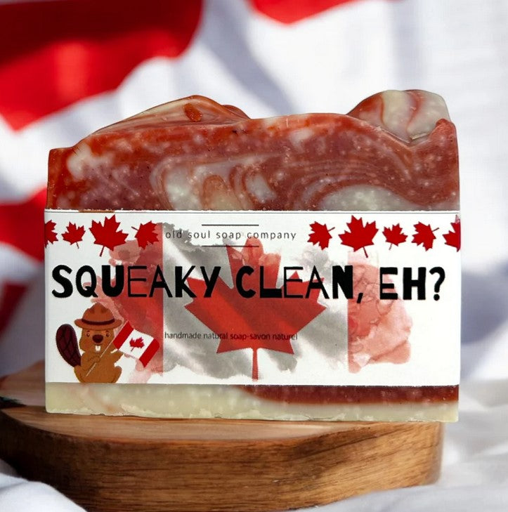 Squeaky Clean Eh vegan Canadian soap bar on wood with flag backdrop, handcrafted by Old Soul Soap Company