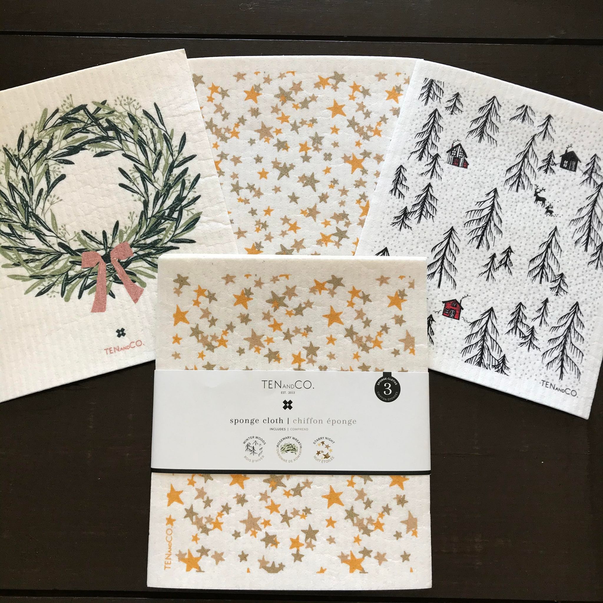 This set of three eco-friendly holiday sponge cloths include one of each pattern rosemary wreath, multi star and tree with cabins on a white background. The cloths will clean all kitchen and bath surfaces without streaking. Great for granite, stainless steel, laminate and glass top stove. 