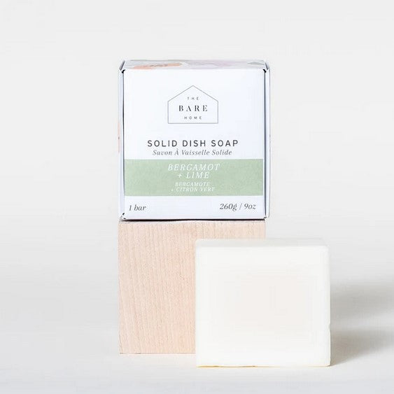 The plant powered suds in this bergamot lime solid dish soap made in canada by the bare home is tough enough to cut stubborn grease and baked on food. It is shown on a white background beside the box it comes in.