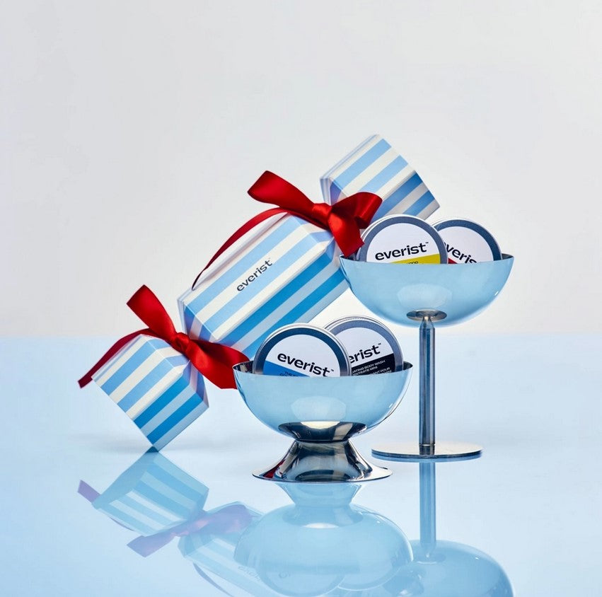 Close-up of the mini travel set’s compact, textured cream tubes with delicate scent labels and clear ingredient details on