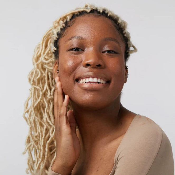 Close-up of the dewy bronze shimmer formula in a clear tube, highlighting its smooth, lightweight texture and natural glow