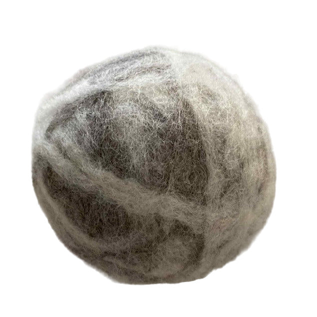 Close-up of Canadian made XL wool dryer ball – eco-friendly laundry essential handcrafted from 100% corriedale wool.