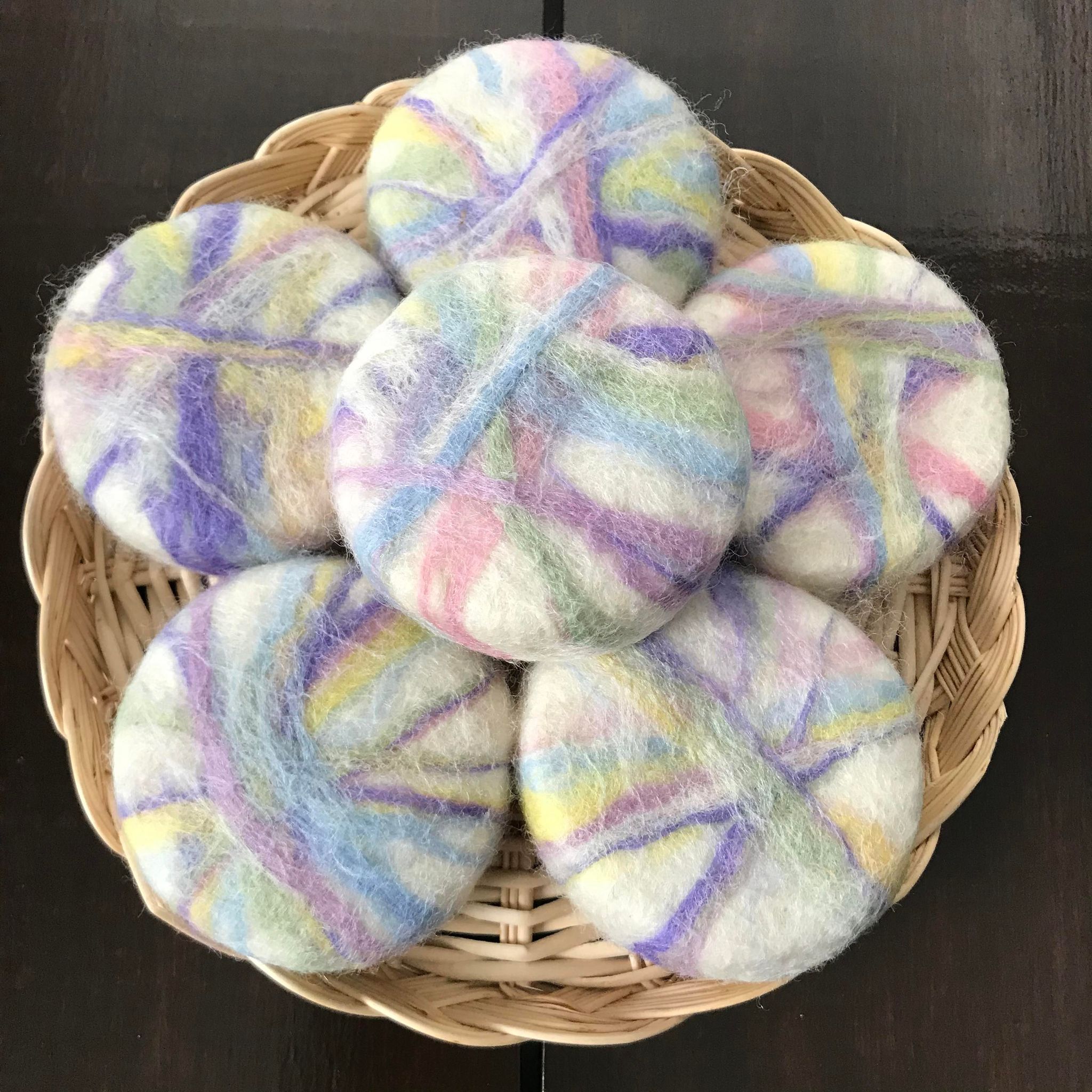 canadian made cedar sage essential oil simply natural canada round soaps on a wicker tray hand felted in spring easter shades on a white background using 100 per cent wool