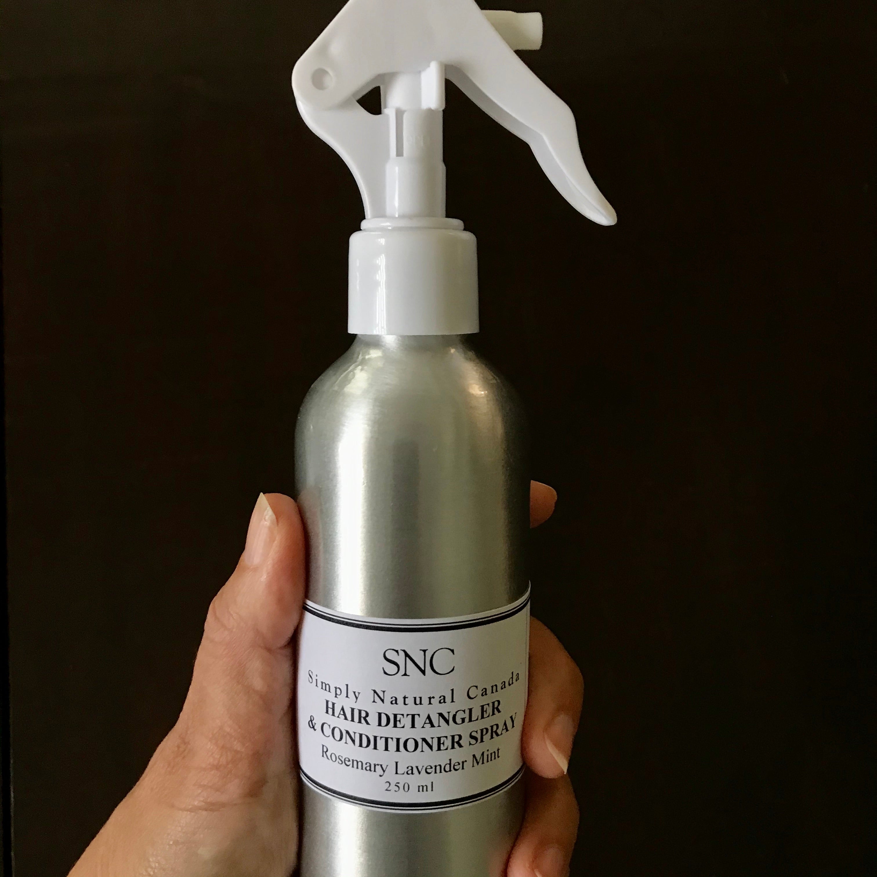 Close-up of the spray nozzle and textured mist, highlighting even application and convenient styling on damp hair