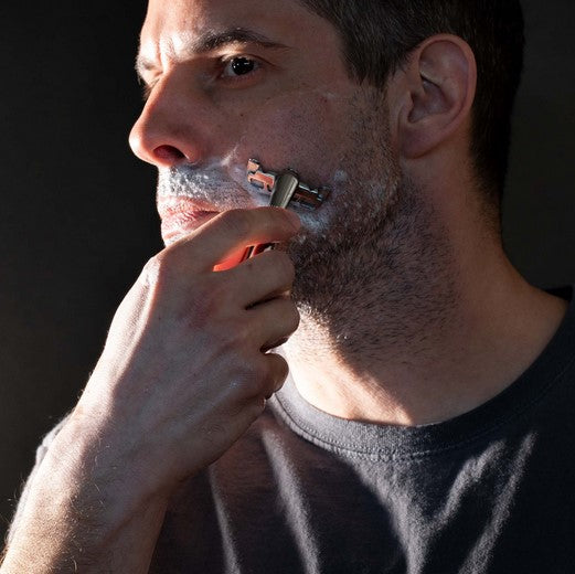 Man shaving coarse facial hair with Leaf Shave Thorn Razor in Mercury finish