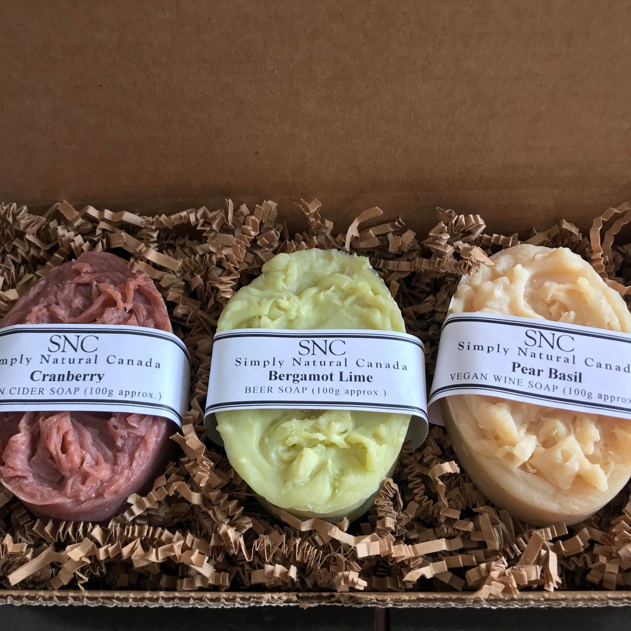 Handcrafted small batch oval vegan soap gift set featuring cranberry cider soap, bergamot lime beer soap and pear basil wine soap in a gift box made in canada by simply natural canada
