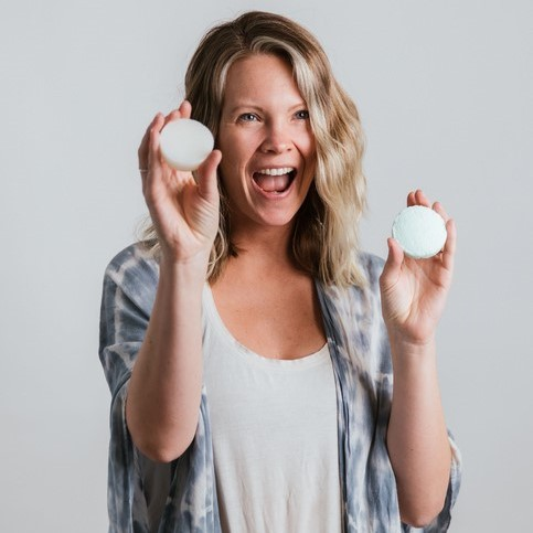 Blonde women holding BeClear shampoo and conditioner bars from Bottle None