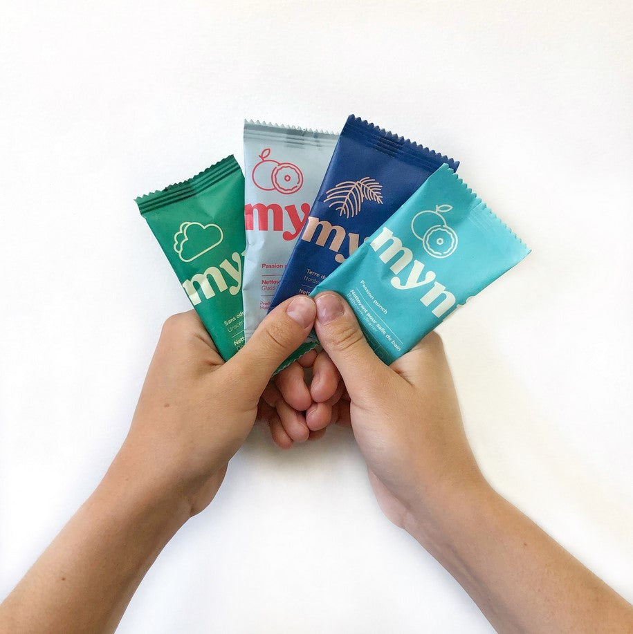 A sample of the Canadian made spray cleaner tablets in compostable pouches held in two hands