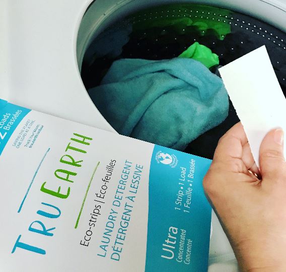 A TruEarth laundry strip about to be put into a washing machine