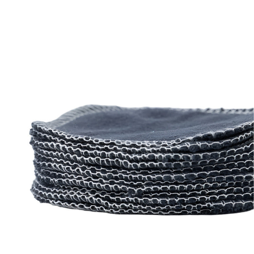 Set of 12 charcoal reusable facial rounds, 2 ply, approximately 3" diameter, 100% cotton flannel in a stack on a white background. These rounds come with a 100% organic cotton laundry bag, 10"x9" made in Canada by Cheeks Ahoy.