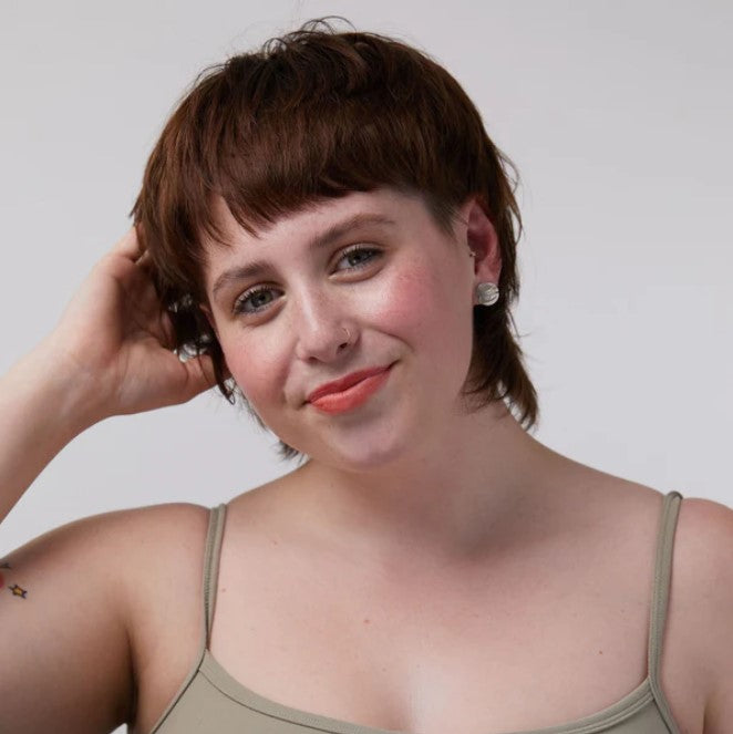 Sunny coral lip and cheek tint worn by a white female model