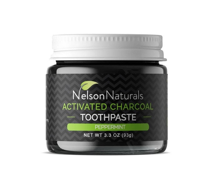 Canadian made Activated Charcoal peppermint flavored toothpaste by Nelson Naturals in a clear 93 g/3.3 oz glass jar with a white lid. Shown pictured on a white background.
