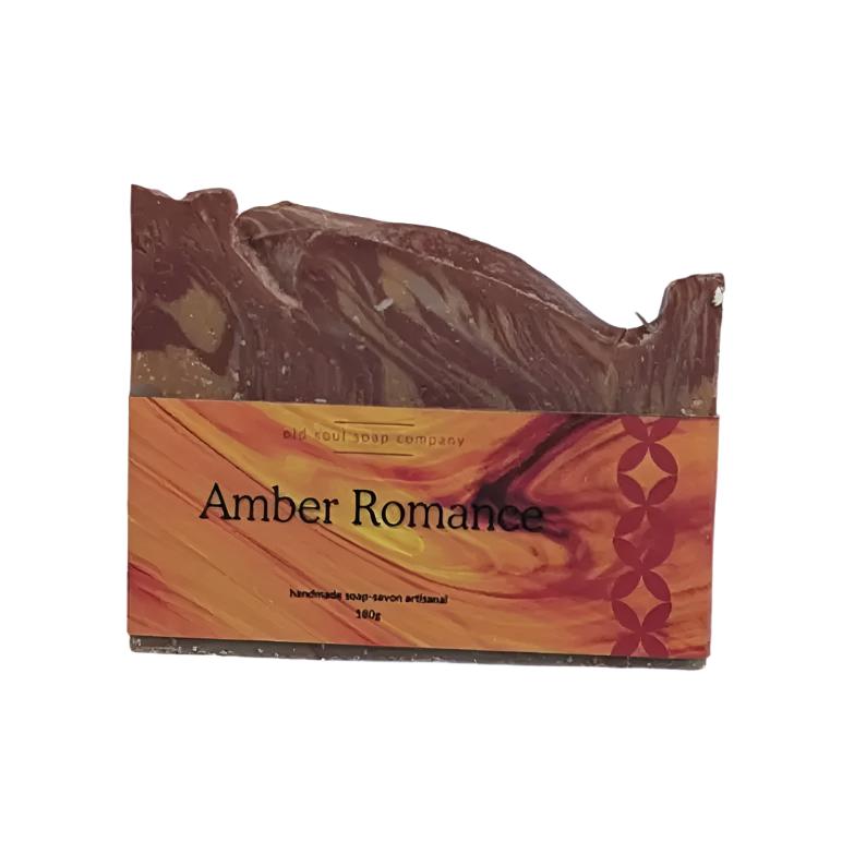 Artisan top spicy fragrance 180 g brownish marble coloured bar soap made in Canada. It has an orange label with red accents with the name 'Amber Romance' on it. The soap is displayed on a white background.