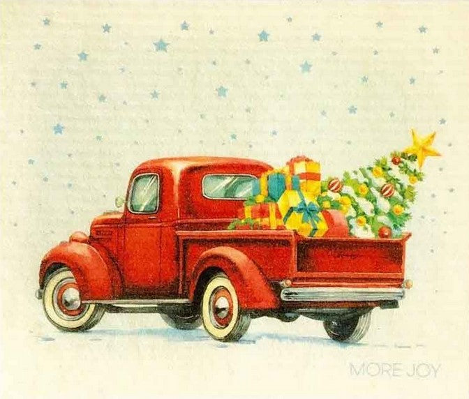 Compostable eco sponge cloth made of cellulose and featuring a classic red pickup truck complete with gifts and a decorated tree in the truck bed, replaces paper towel by absorbing 20x its weight in liquid. Size 20 x 17 cm