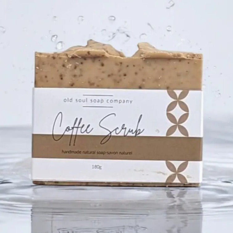 This natural vegan coffee soap made in Canada to gently exfoliate skin and remove odors from hands is shown labeled and on a white watery background.