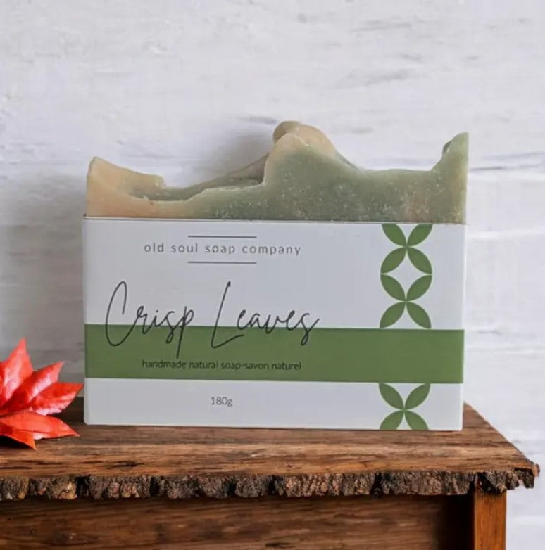 A natural bar of soap 180 g. with a Crisp Leaves label sits on a wood bench. This Canadian made soap features a refreshing blend of eucalyptus, lemongrass, peppermint and lavender.