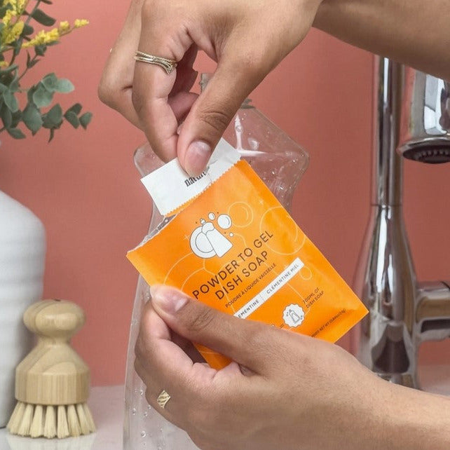 One compostable pouch of honey clementine scented powdered dish soap from Nature Bee makes 700 ml of gel dish soap when you add water.