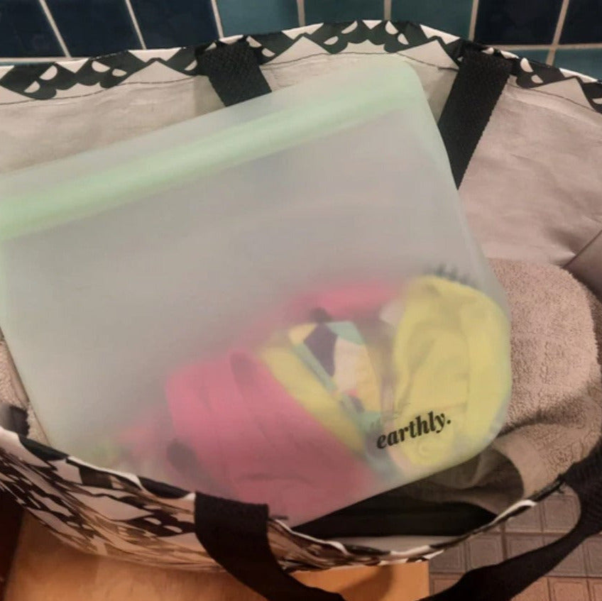 Extra large Earthly Change silicone storage bag holding wet clothes inside a swim tote