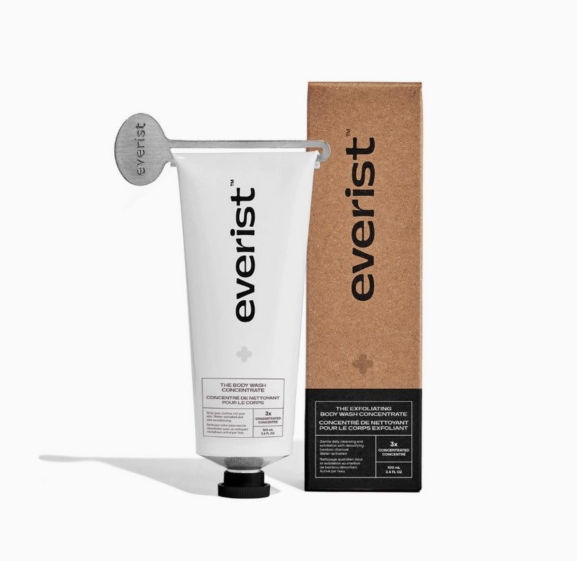 Everist exfoliating body wash in a tube sits beside its Kraft paper box on a white background